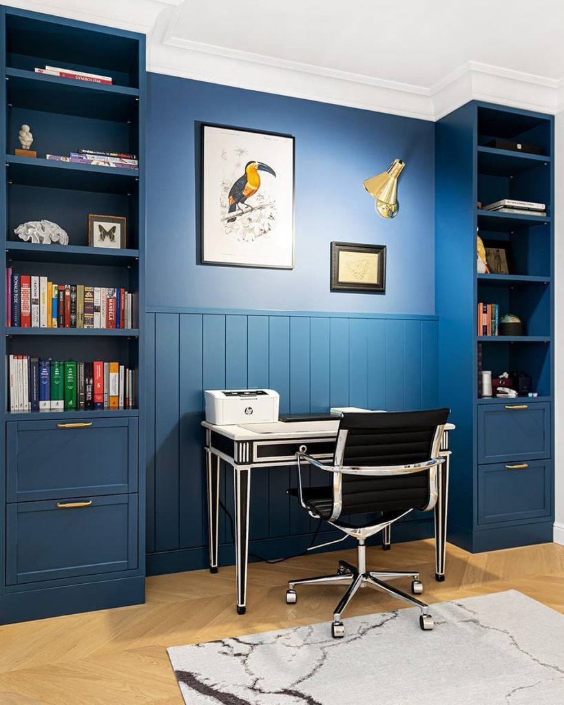 Home office with dark blue colored walls