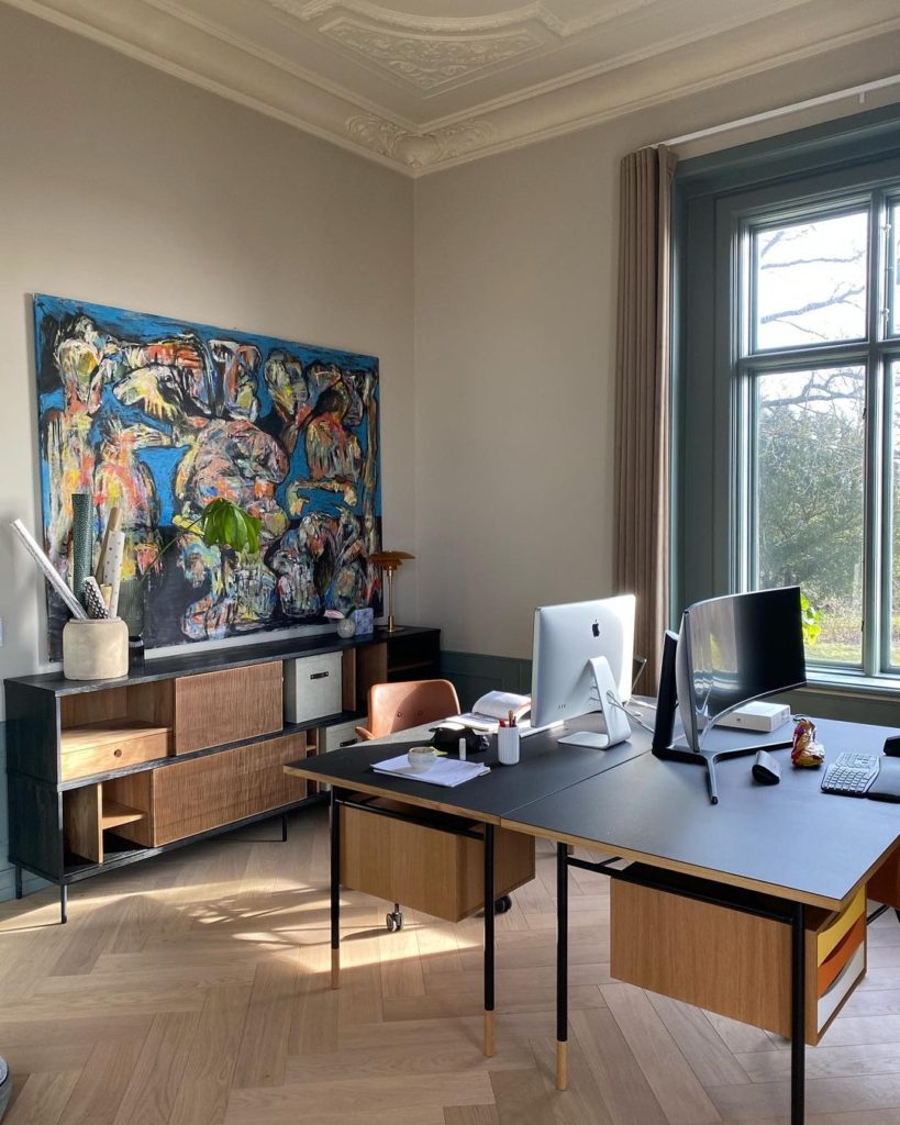 Home office with brown walls and 2 desks and computers