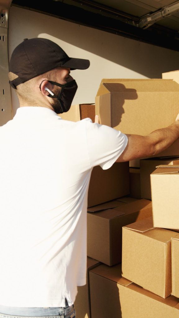 Mover (man) taking out a box from a truck