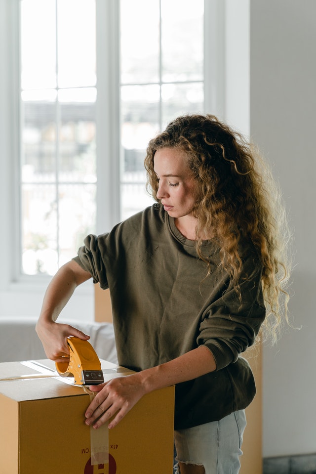 Woman packing clothes to donate.