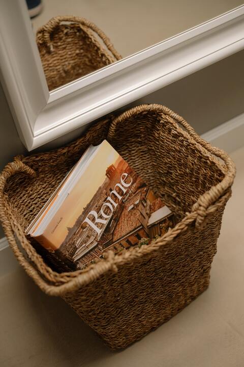 Wicker basket to store books.