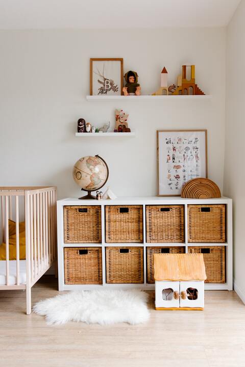 Square wicker baskets as bedroom storage.