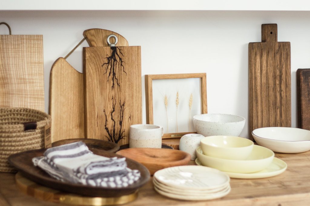 Wooden boards, plates, and a basket. 