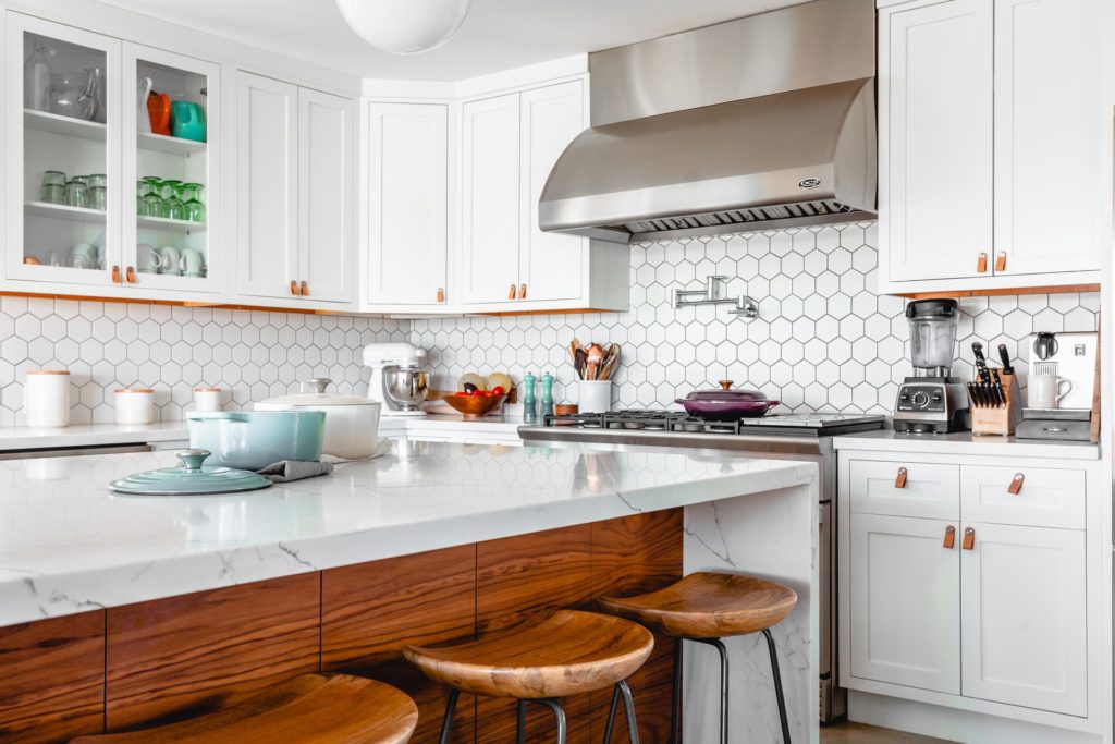 White kitchen with kitchen utensils, tools, and appliances.