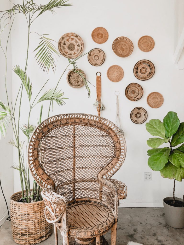 Many flat round baskets on the wall. 