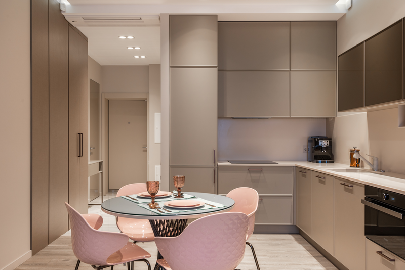 Pastel colored chairs in a neutral kitchen