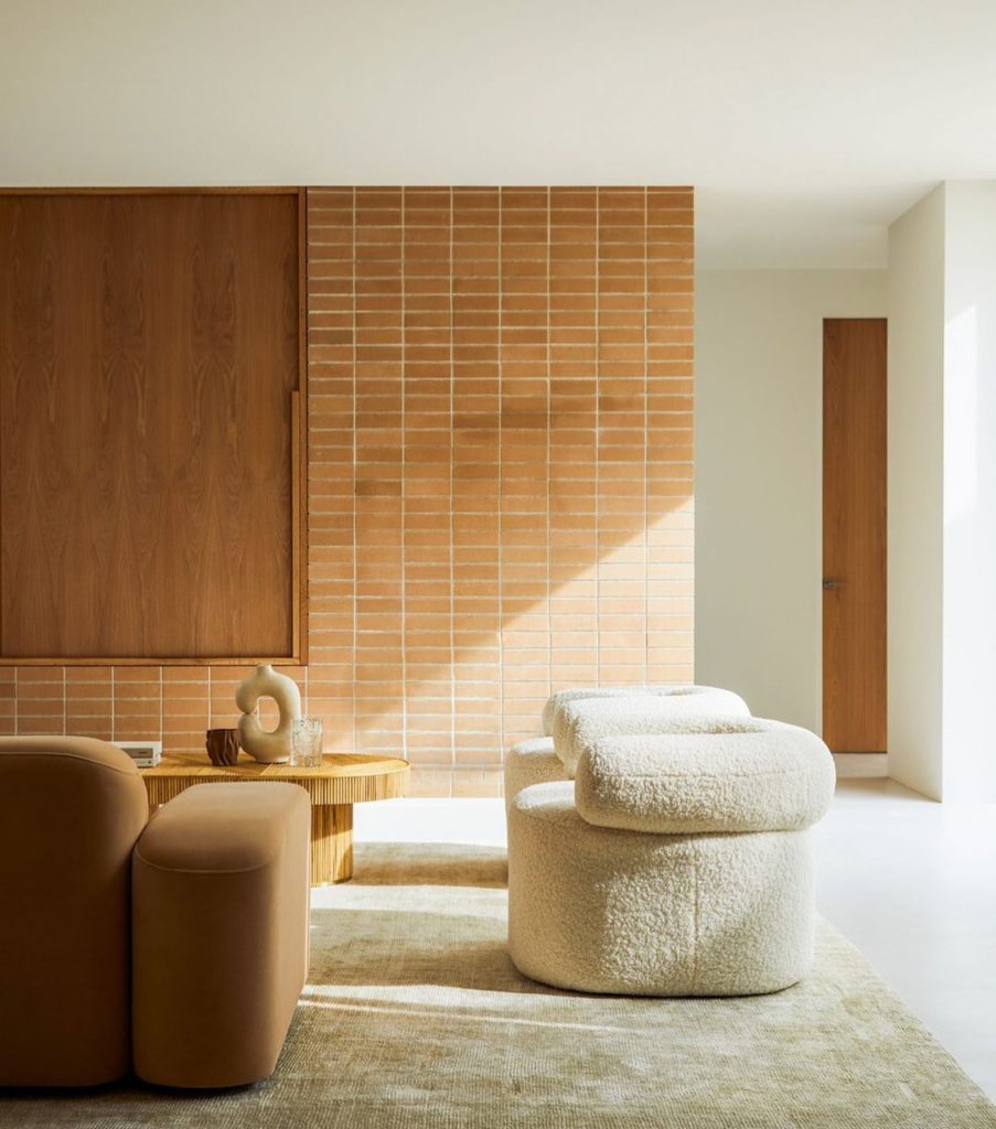 Sunlight in a minimalist living room with white and brown sofa