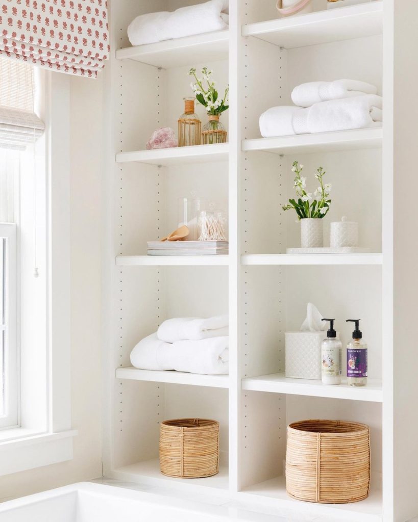 Bathroom shelf with towels, skincare, tissue paper and baskets