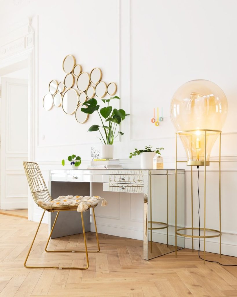 Luxurious office with gold chair and glass table