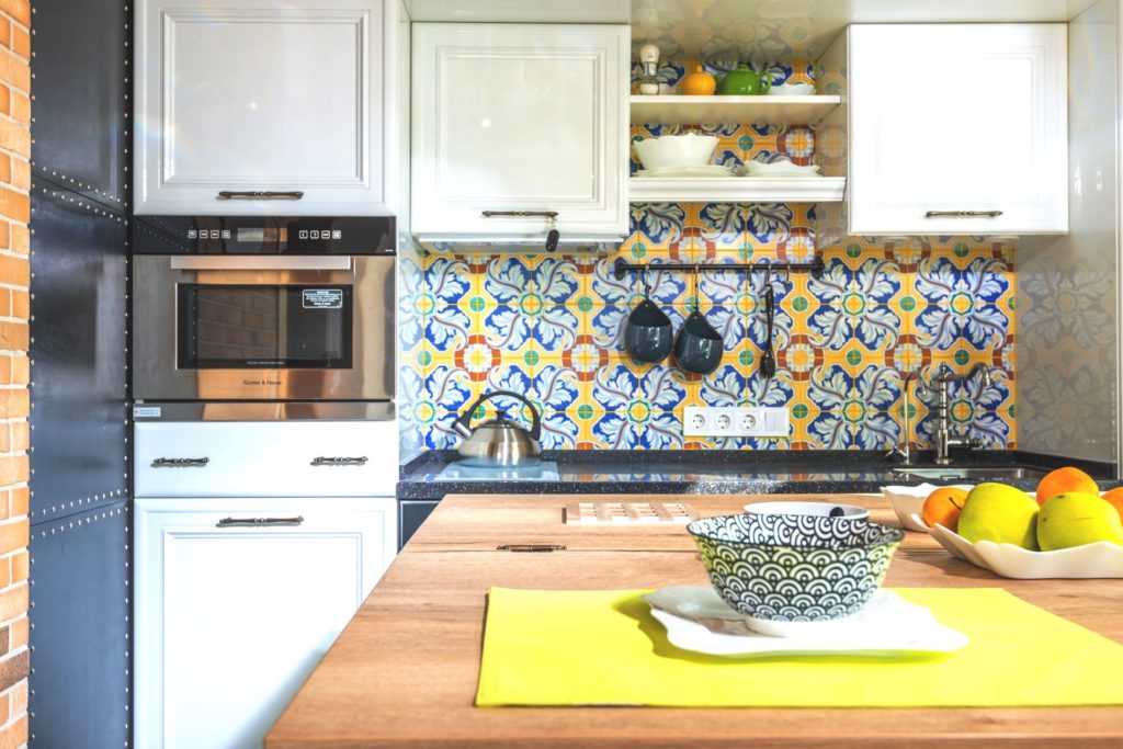 White kitchen with colorful yellow and blue backsplash