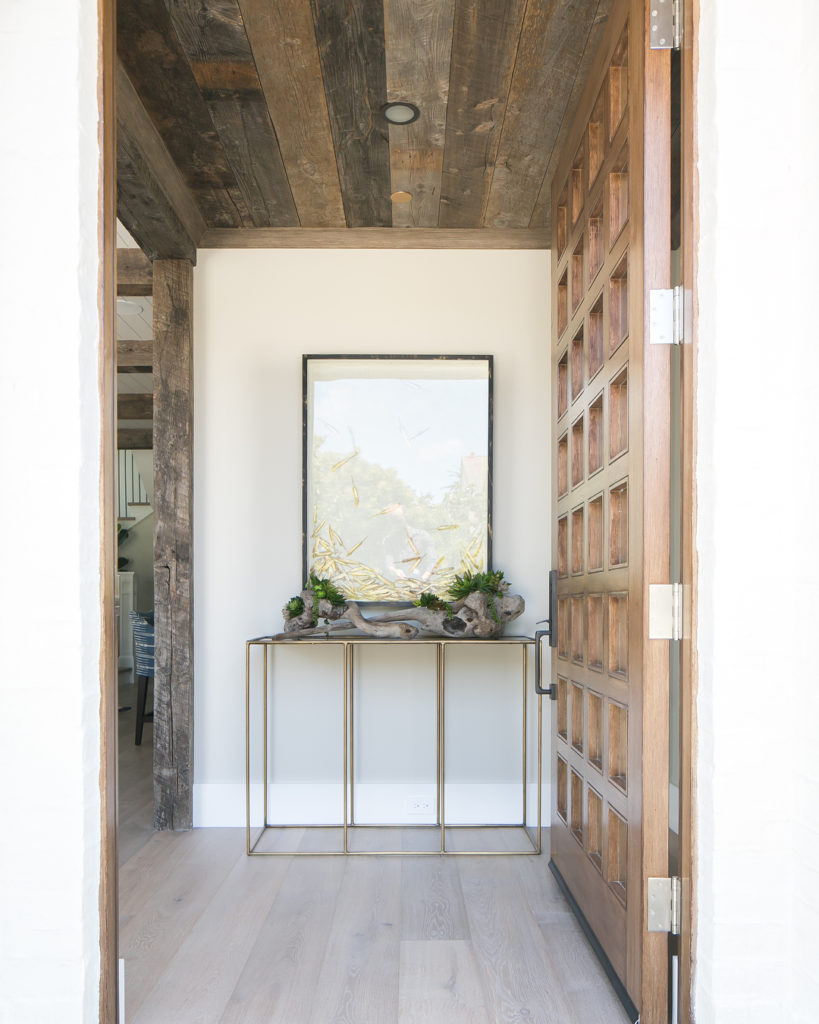 A beautiful entryway that made use of logs and plants to emphasize nature.