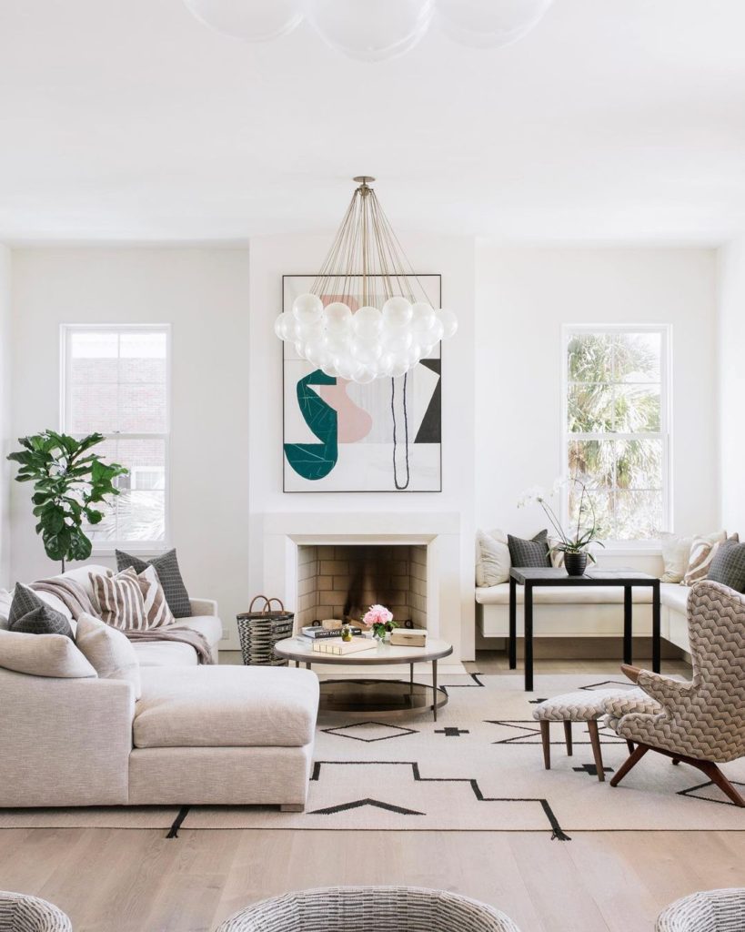 Traditional white living room with white sectional sofa. 