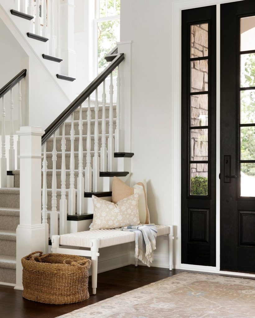 White foyer entryway with a small white bench