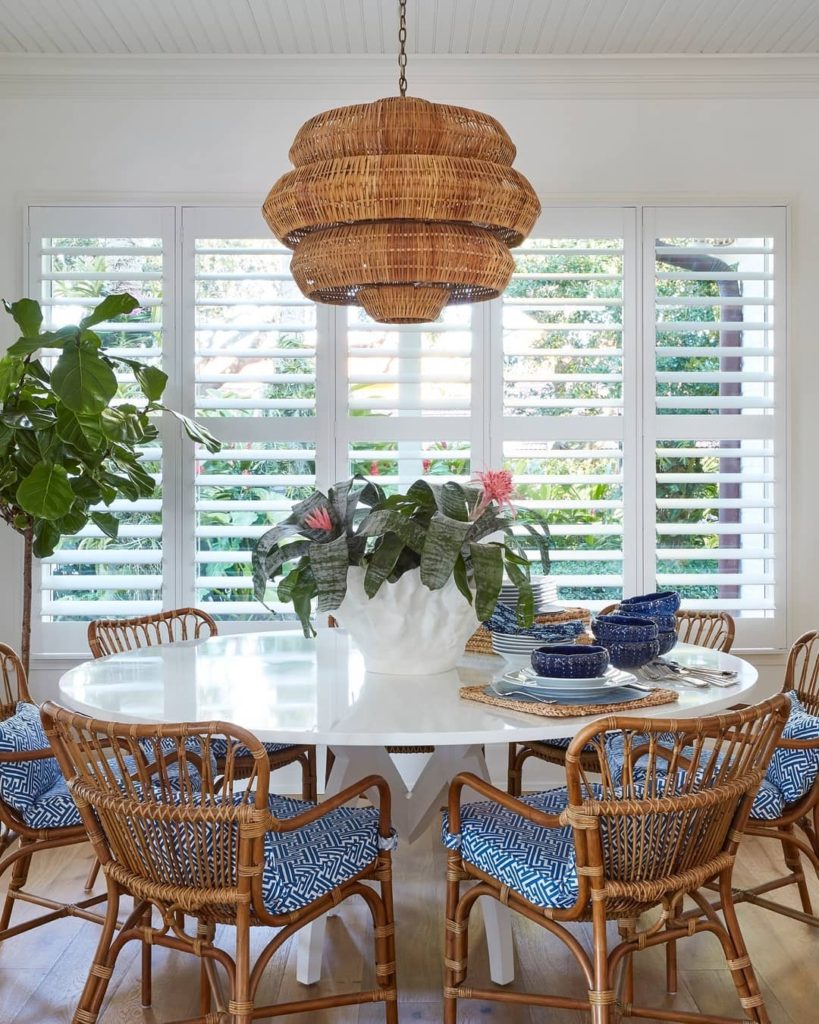 Rattan chairs in a casual dining setting coastal style.  